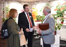 Eric Juckers of Prudac in conversation with Marie - Anne Haaring and Herman Scholten of Royal Administration International.